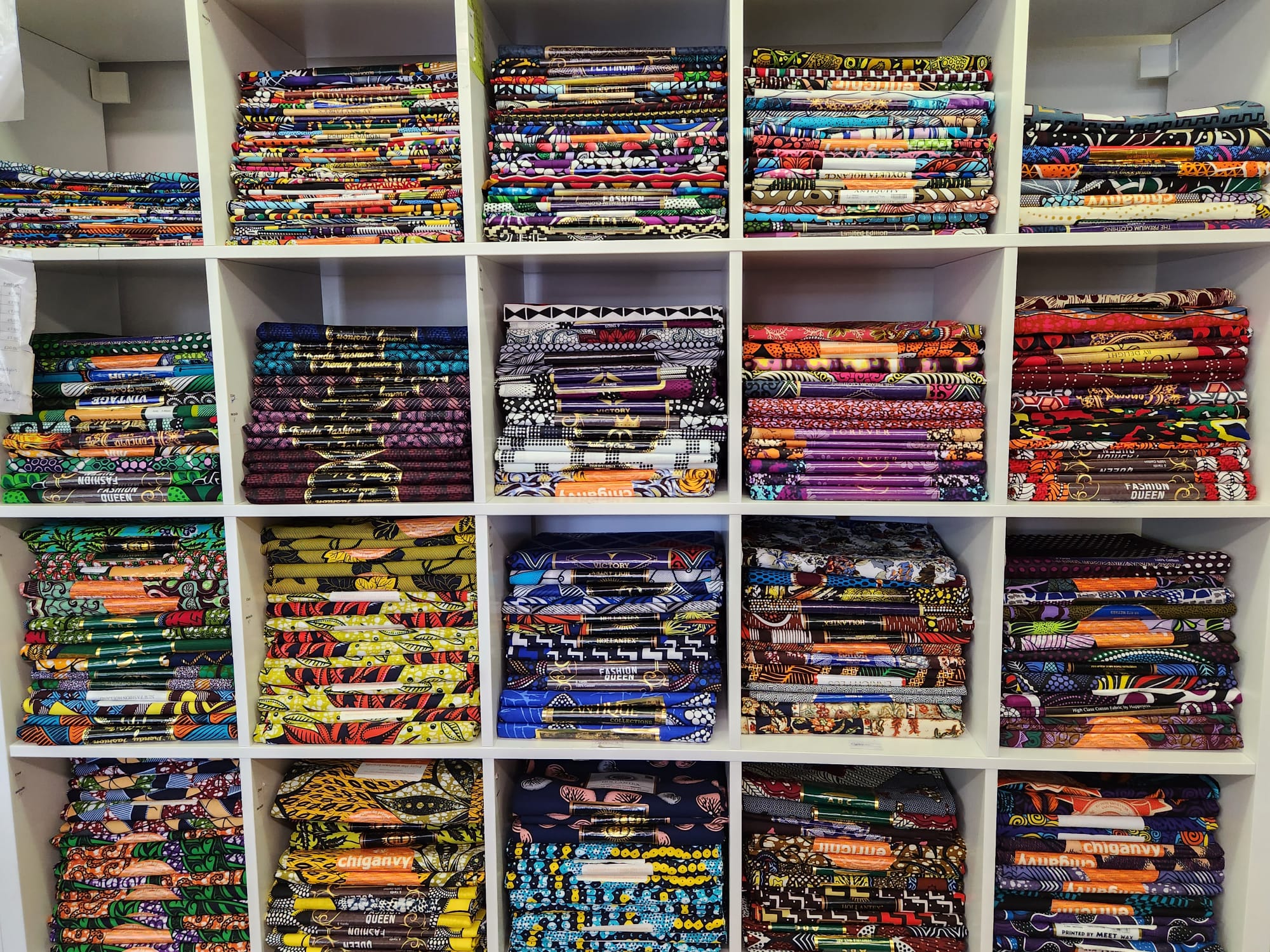 Hundreds of Colourful African Print Fabrics stacked up in shelves