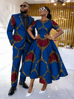 Couple styled in royal blue and crimson Ankara — man in tailored suit, woman in flare dress