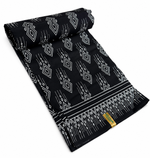 Black and white geometric diamond African wax print cotton fabric rolled on white background showing full width and selvedge border