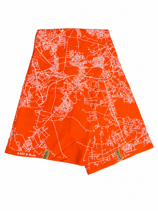 Orange abstract map print African wax cotton fabric folded on white background showing full print detail