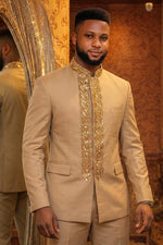 Man wearing a champagne gold African Prince suit with heavy gold sequin and bead leaf embroidery on placket and Mandarin collar, paired with matching trousers