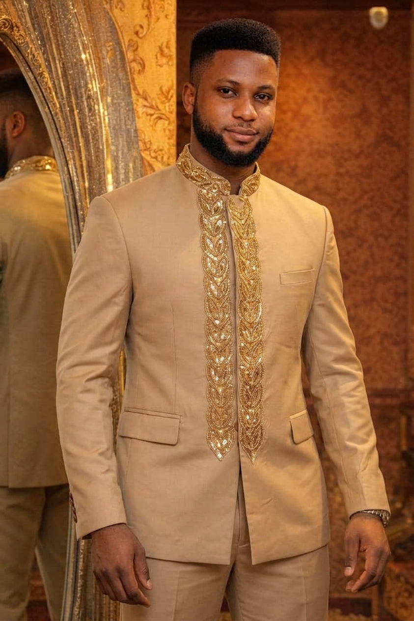 Man wearing a champagne gold African Prince suit with heavy gold sequin and bead leaf embroidery on placket and Mandarin collar, paired with matching trousers