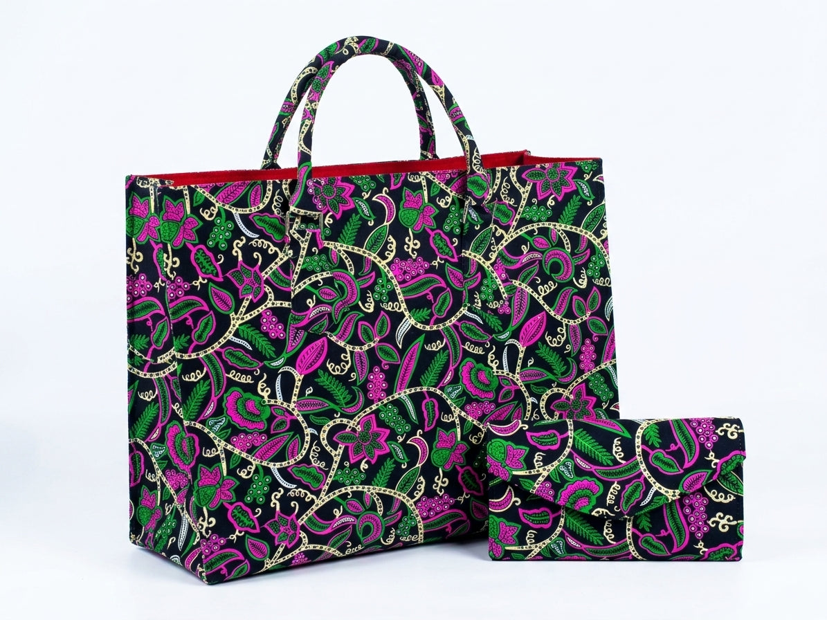 Front view of large Ankara botanical tote bag with matching clutch purse in hot pink, green and cream floral print on black base