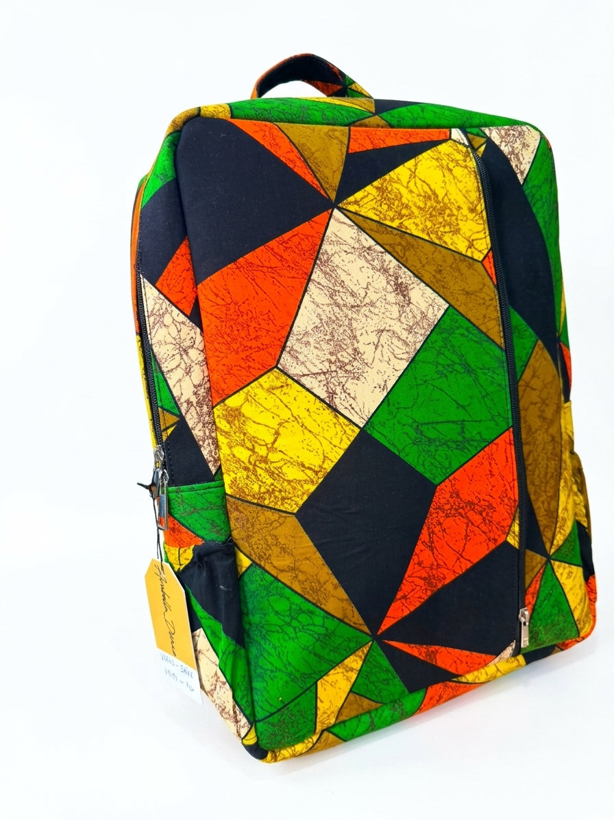 Three-quarter view of Ankara geometric patchwork backpack in green, orange and yellow kaleidoscope print with side zip pocket and House of Prints branded tag