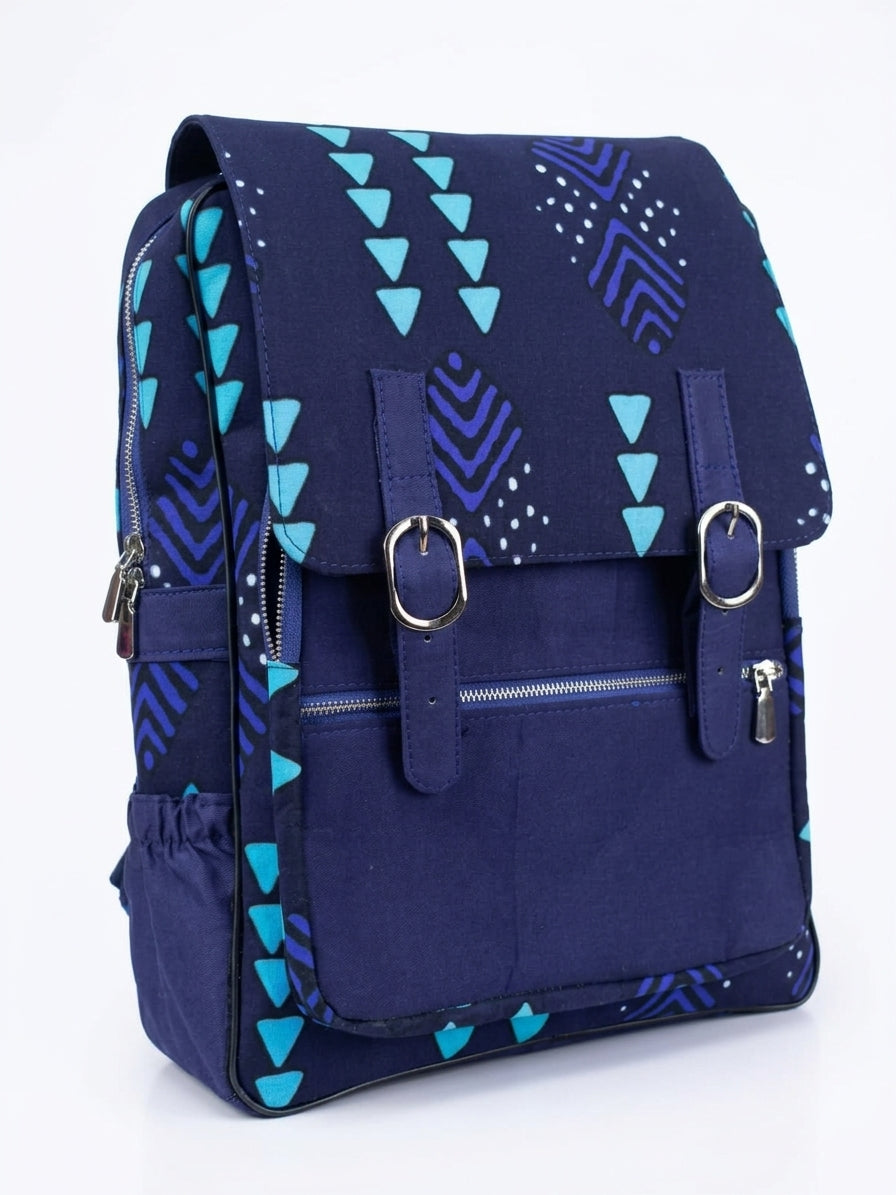 Front view of navy blue Ankara satchel backpack showing fold-over flap with dual silver buckle closure, front zip pocket and padded straps