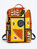 Front view of Ankara mudcloth print backpack in yellow, red, brown and black tribal geometric pattern with brown leather top handle