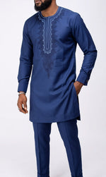Close-up front view of men's navy blue embroidered senator suit showing intricate scrollwork and floral bib embroidery detail and button cuffs