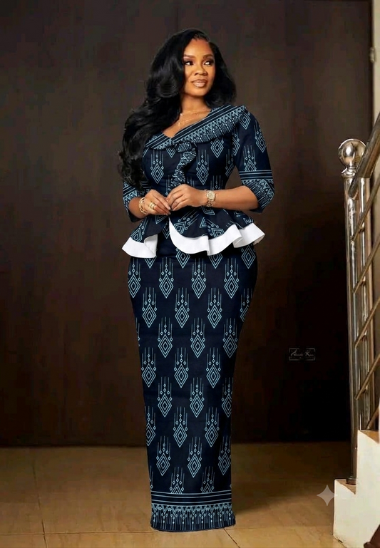 Woman wearing a navy blue geometric diamond African wax print peplum skirt suit at a formal event