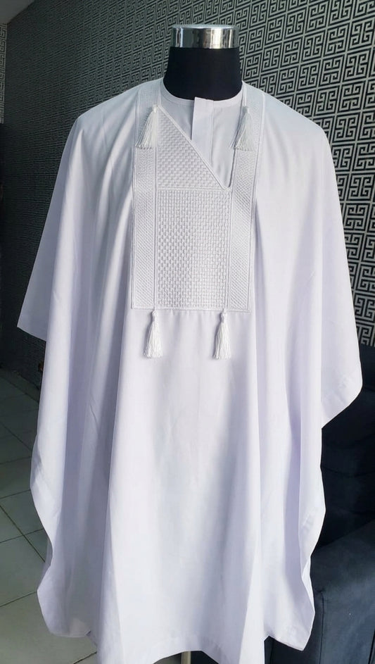 Men's white embroidered Nigerian Agbada Babariga on mannequin, featuring tonal geometric chest embroidery and white tassel ties
