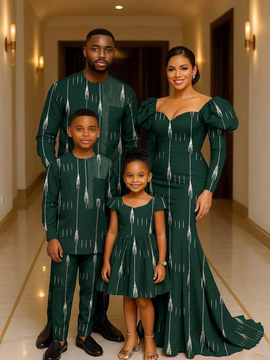 Family of four wearing coordinated emerald green ikat streak African wax print outfits — man in senator set, woman in puff-sleeve mermaid gown, two children in matching dress and suit