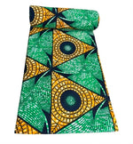 Green and gold geometric fan Ankara wax print fabric unrolled showing full pattern detail