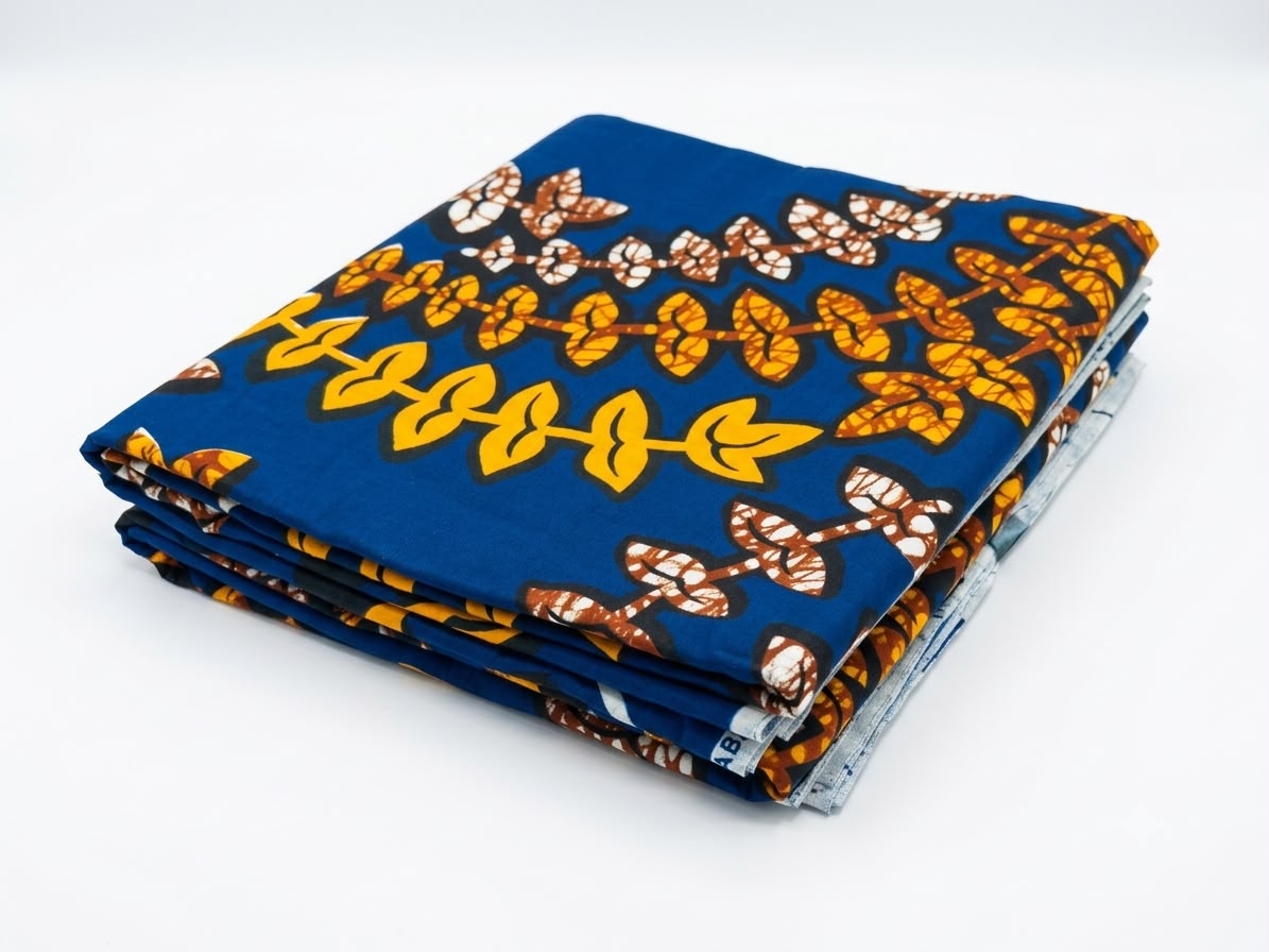 Royal blue and gold leaf vine Ankara wax print cotton fabric folded neatly showing full pattern