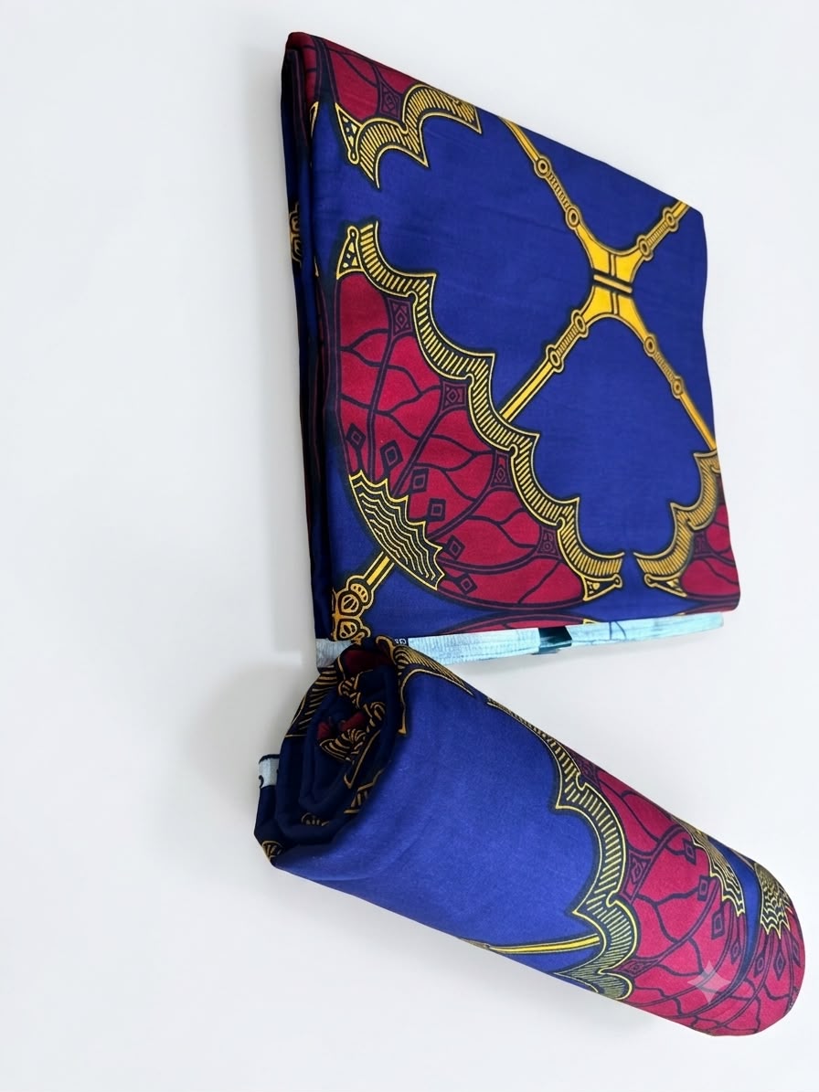 Royal blue and crimson medallion Ankara fabric shown folded and rolled