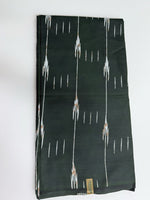 Emerald green ikat streak African wax print cotton fabric folded flat on white background showing full print detail and selvedge label