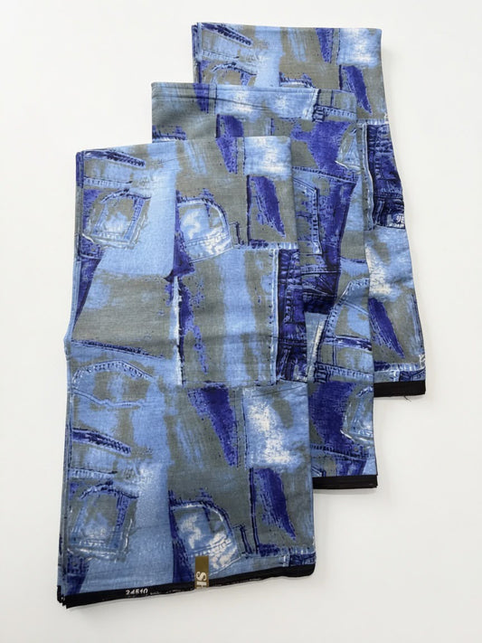 Family of four wearing matching denim patchwork print Ankara outfits — dad, mum, son and daughter coordinated