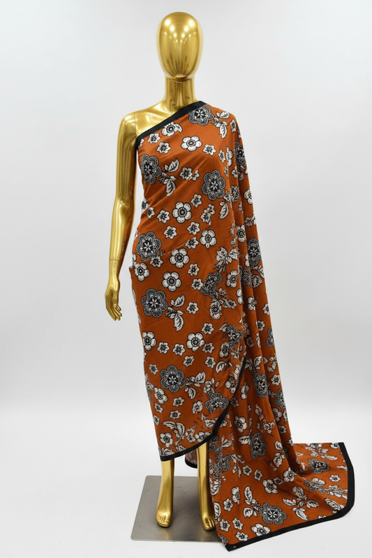 Rust and white floral Ankara wax print fabric draped on a gold mannequin