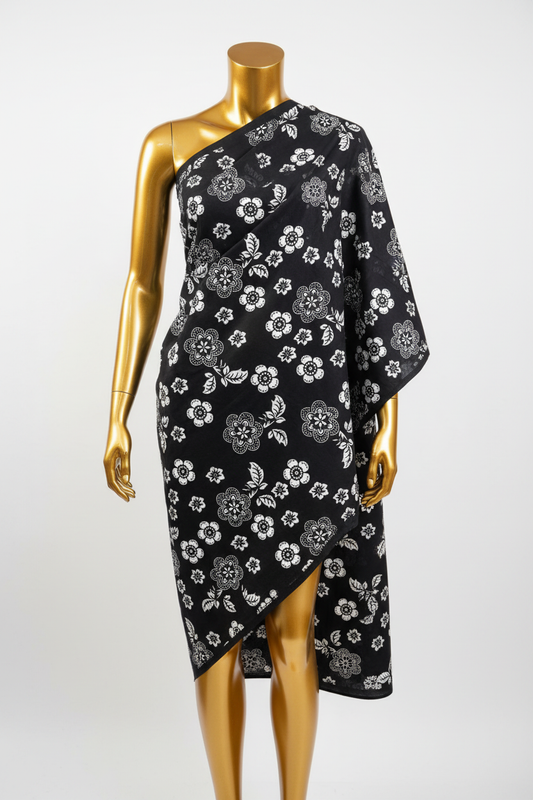 Black and white floral Ankara wax print fabric draped on a gold mannequin