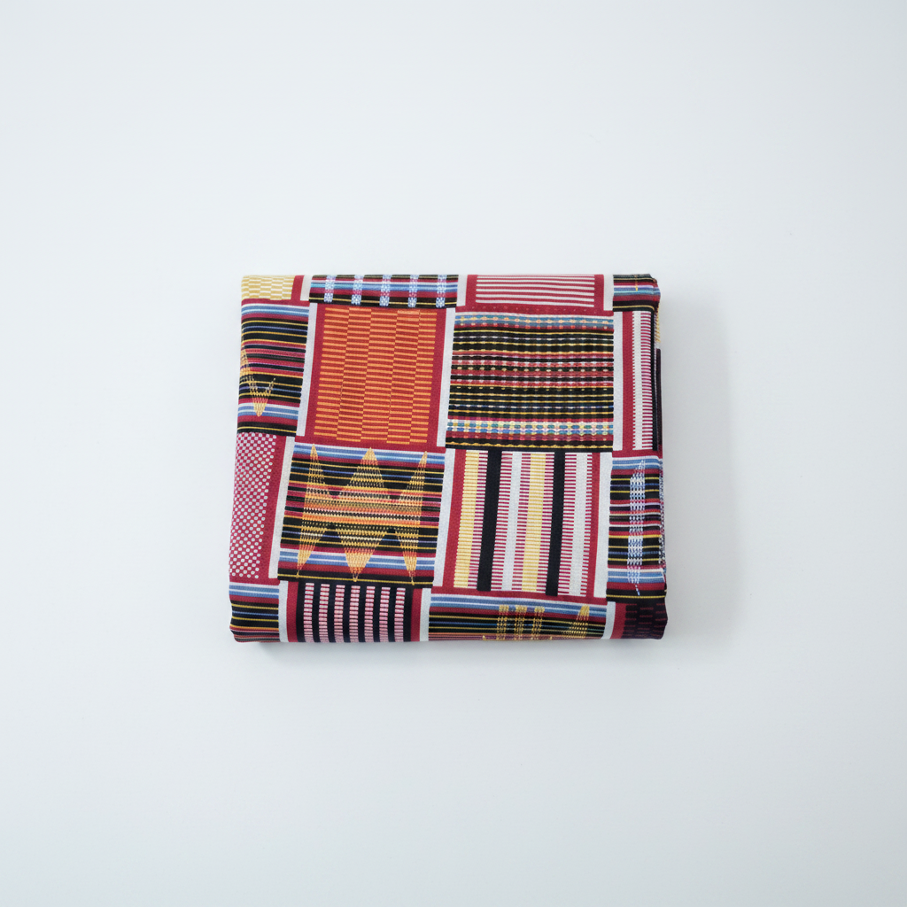 100% cotton Ankara Kente fabric flat lay — red geometric patchwork print, studio product shot on white background