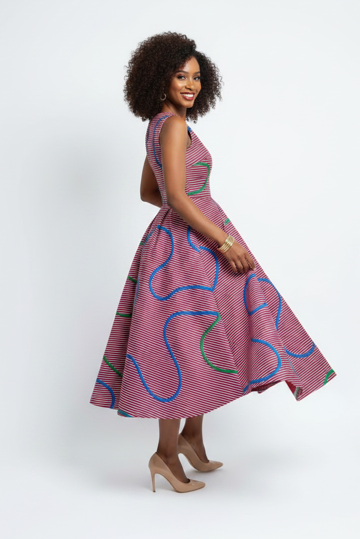 Mixed race model in fit and flare Ankara dress, three-quarter turn pose