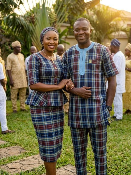 Folded navy blue tartan check African print fabric showing plaid weave detail with burgundy, sky blue and yellow accents